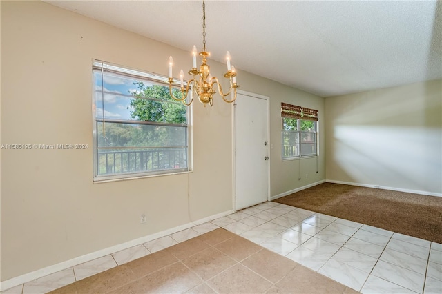 tiled entryway featuring an inviting chandelier