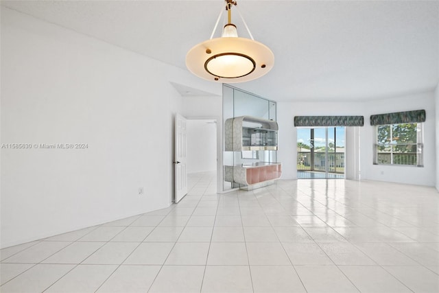 unfurnished living room featuring light tile floors