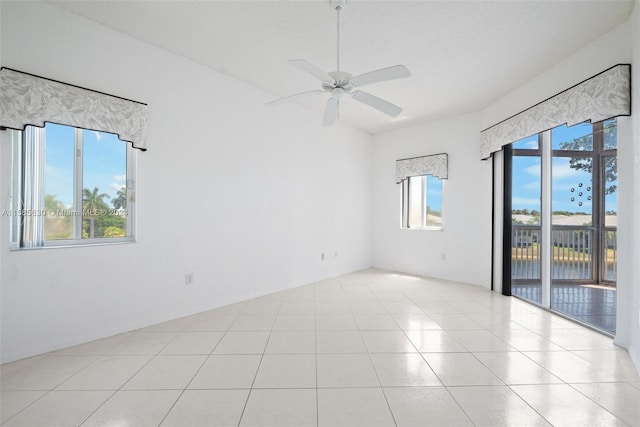 tiled empty room featuring ceiling fan