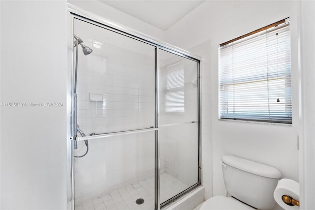 bathroom with walk in shower and toilet