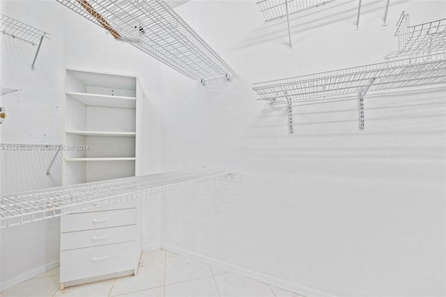 walk in closet featuring light tile floors