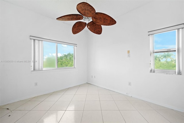 empty room featuring ceiling fan and light tile floors