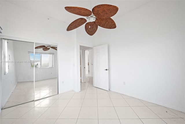 unfurnished bedroom featuring a closet, ceiling fan, and light tile floors