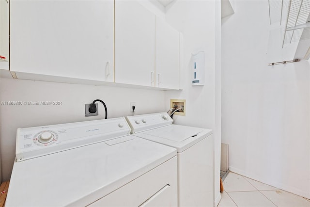 laundry area featuring cabinets, washer and dryer, washer hookup, electric dryer hookup, and light tile floors