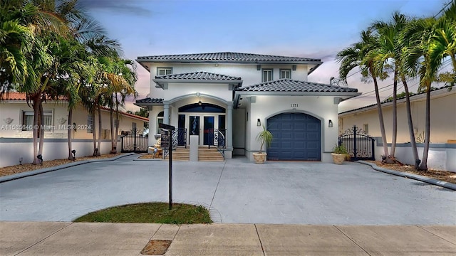 mediterranean / spanish-style house with a garage