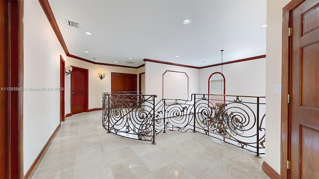 hallway with a notable chandelier, ornamental molding, and light tile floors