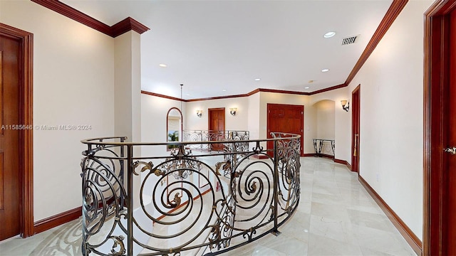 hall featuring crown molding and light tile flooring