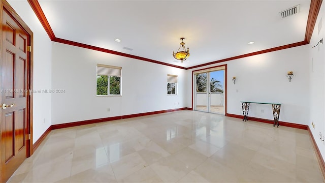 empty room featuring tile flooring and ornamental molding