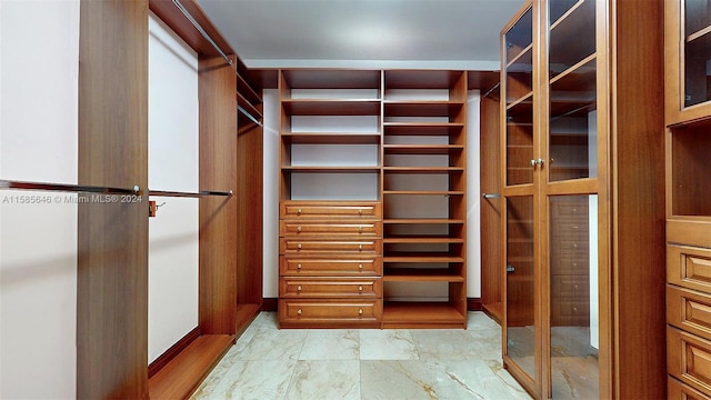 walk in closet with tile flooring