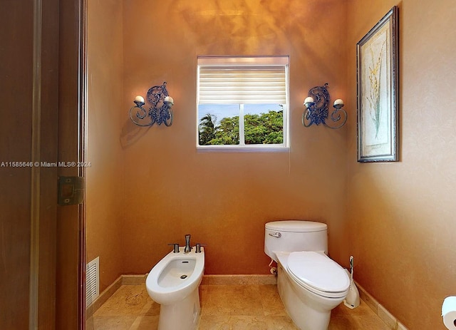 bathroom with a bidet, tile flooring, and toilet