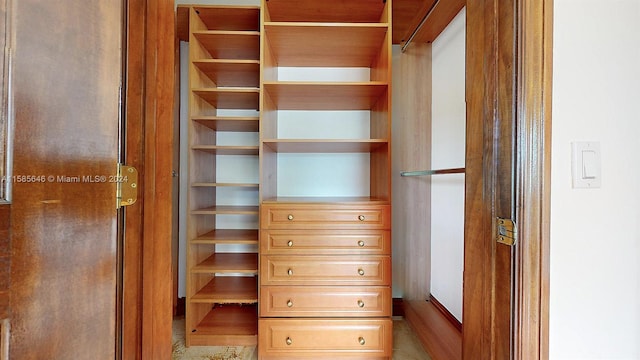 spacious closet with tile floors