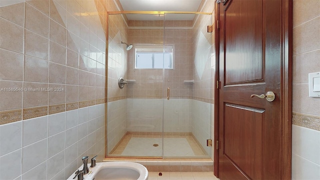 bathroom featuring tile walls and an enclosed shower