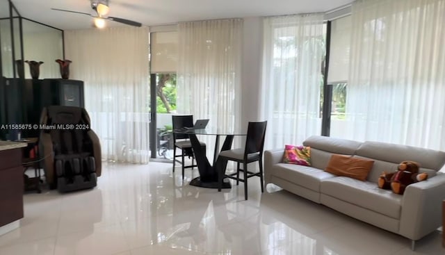 tiled living room featuring a wealth of natural light and ceiling fan