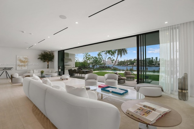 living room featuring a water view and a wall of windows