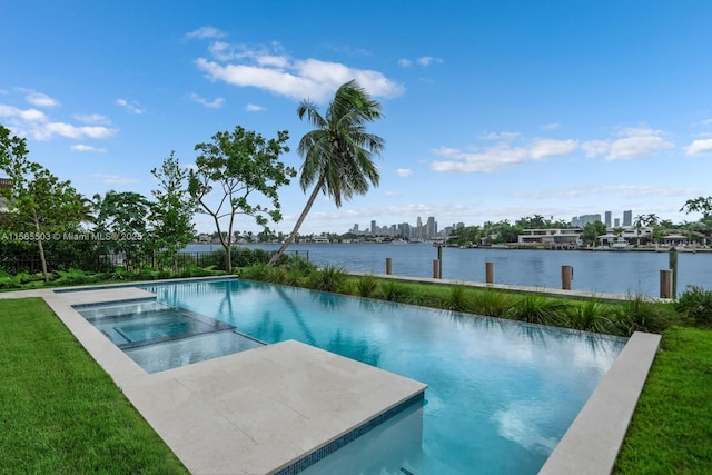 view of swimming pool with an in ground hot tub and a water view