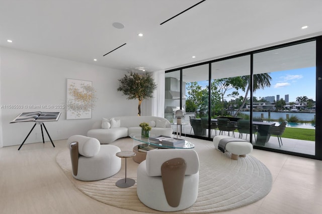 living room with expansive windows and a water view