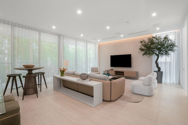 living room featuring expansive windows and light tile patterned flooring