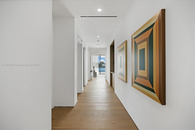 hallway with light hardwood / wood-style flooring