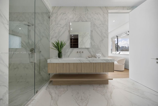 bathroom featuring vanity and a shower with door