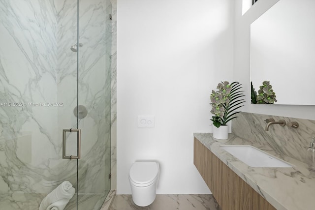 bathroom featuring vanity, a shower with shower door, and toilet