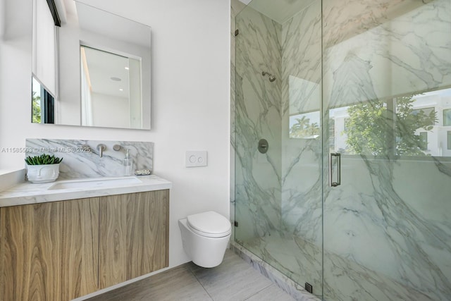 bathroom featuring tile patterned flooring, vanity, toilet, and a shower with door