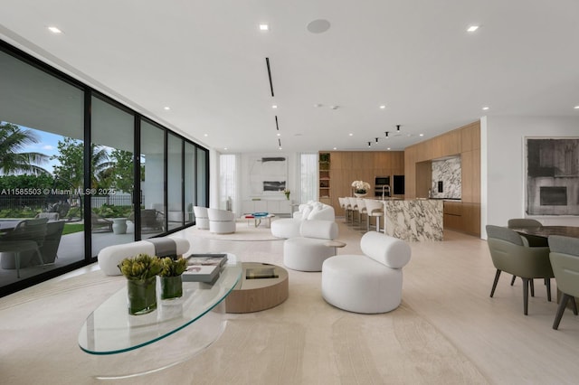 living room featuring a wall of windows and wood walls