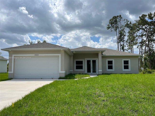 view of front of property with a garage and a front yard