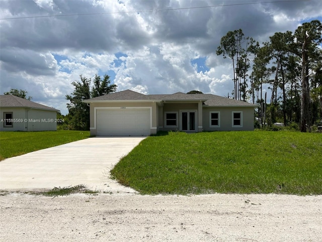 view of front of house featuring a front yard and a garage