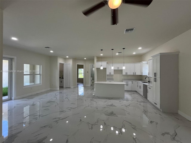 kitchen with a center island, hanging light fixtures, white cabinetry, light tile floors, and ceiling fan