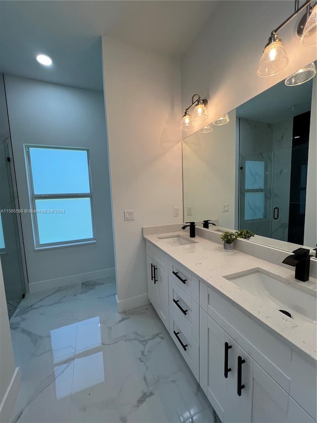 bathroom featuring a shower with door, tile floors, and dual vanity