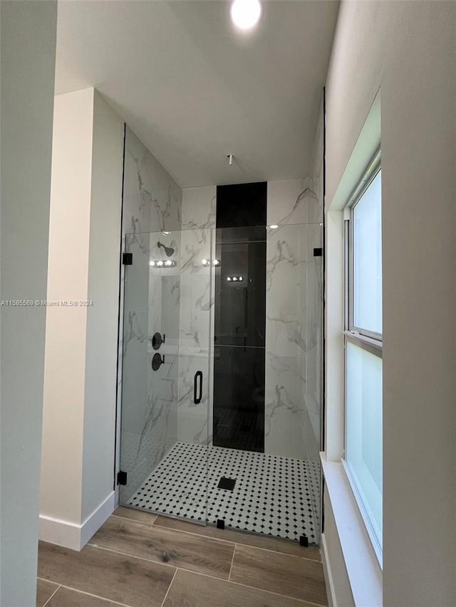 bathroom featuring a shower with shower door