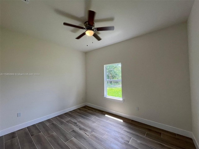 empty room with dark hardwood / wood-style floors and ceiling fan