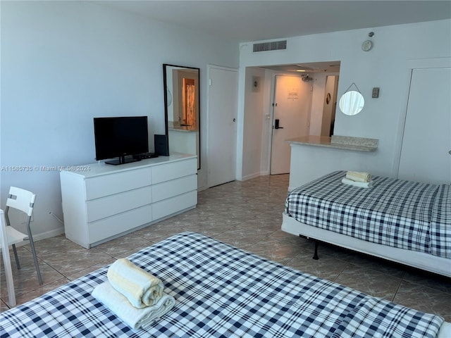 bedroom featuring tile floors