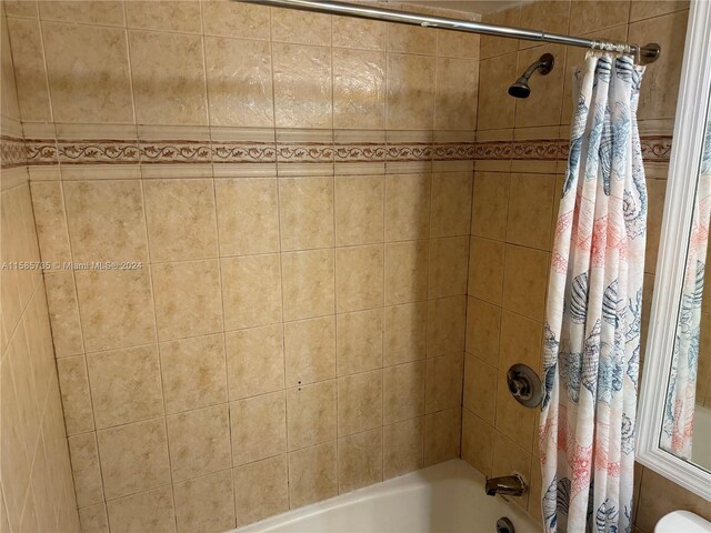 bathroom with shower / bath combo with shower curtain