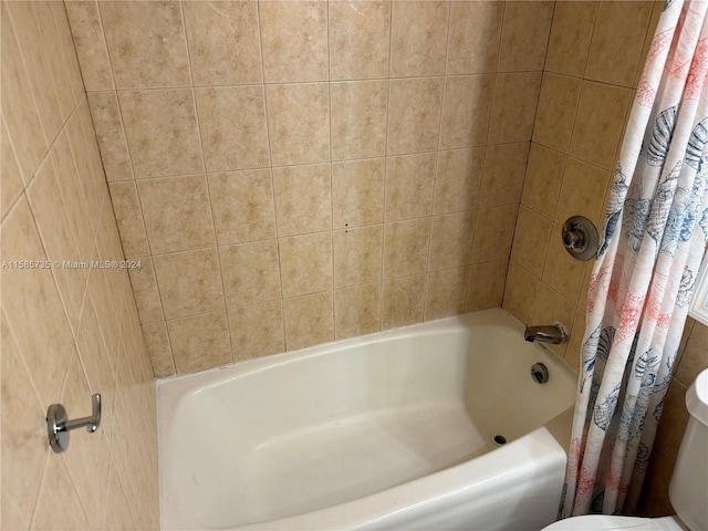 bathroom with toilet and shower / tub combo