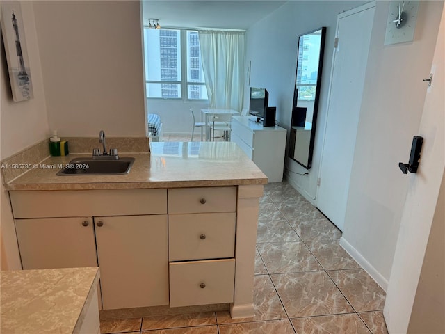 bathroom with tile floors, sink, and a wealth of natural light