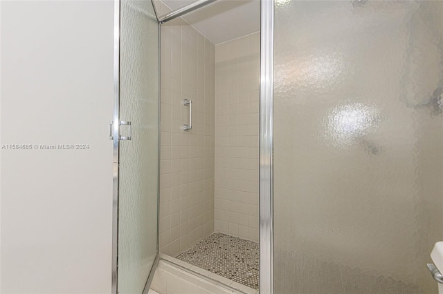 bathroom with a shower with shower door