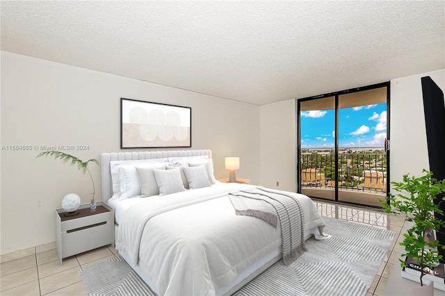 bedroom with access to exterior, a textured ceiling, floor to ceiling windows, and light tile patterned floors