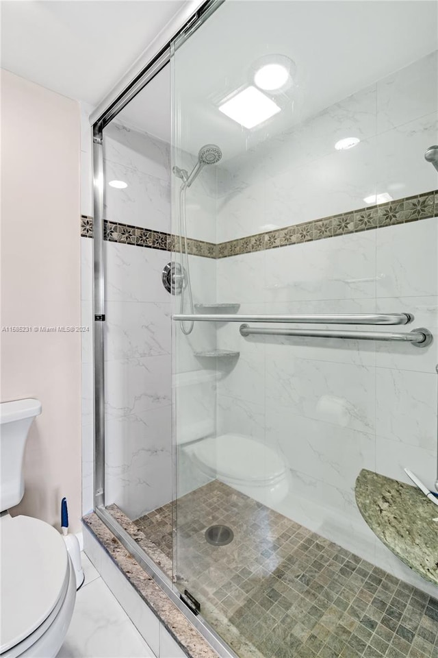 bathroom featuring walk in shower and toilet