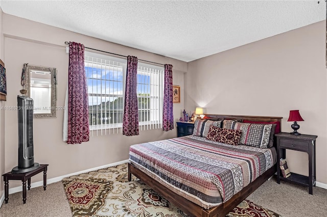 carpeted bedroom featuring a textured ceiling