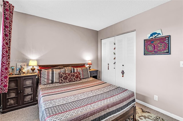 bedroom with a textured ceiling, light carpet, and a closet