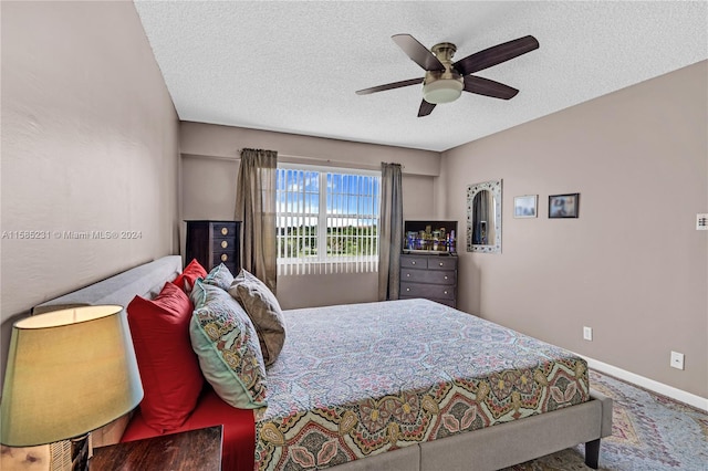 bedroom featuring a textured ceiling and ceiling fan