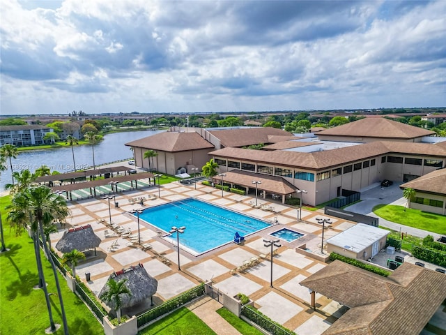 view of pool with a patio and a water view