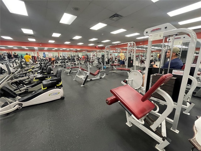 gym featuring a paneled ceiling