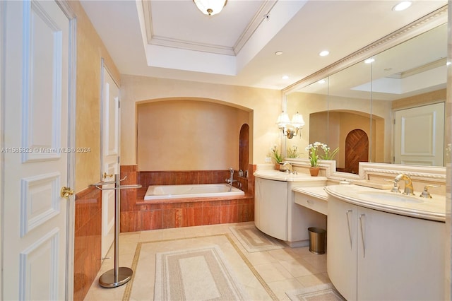 bathroom with a raised ceiling, vanity, tile floors, and tiled tub