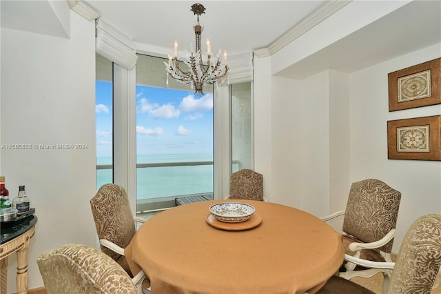 dining room featuring a chandelier, a water view, and a wealth of natural light