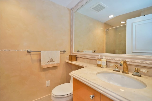 bathroom with vanity with extensive cabinet space and toilet