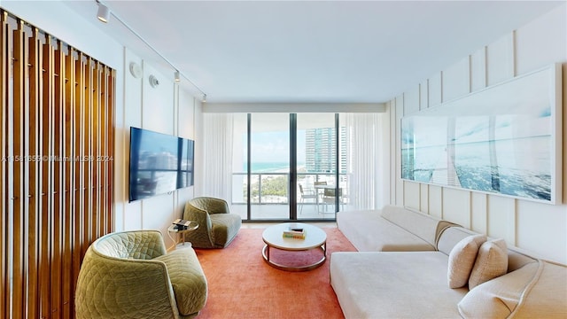 living room with floor to ceiling windows and track lighting