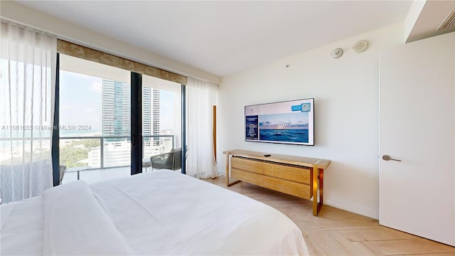 bedroom with access to outside and parquet floors