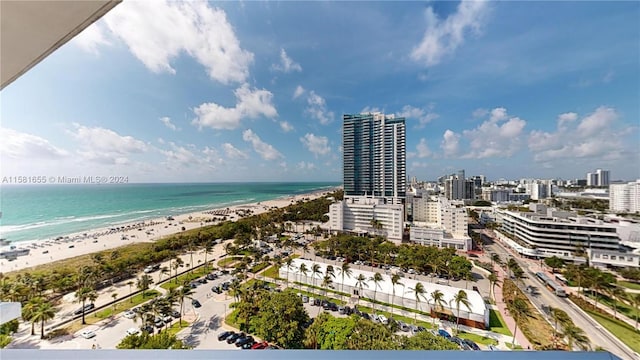 drone / aerial view with a beach view and a water view